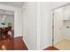 Hallway with hardwood floors and view to the kitchen and laundry room with cabinetry at 2254 Show Basket Way, Mount Pleasant, SC 29466