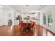 Open-concept kitchen features white cabinets, granite countertops, stainless steel appliances, and eat-in kitchen with orange chairs at 2254 Show Basket Way, Mount Pleasant, SC 29466