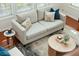 Bright living room featuring a comfortable couch, stylish pillows, and a neutral-toned rug at 2254 Show Basket Way, Mount Pleasant, SC 29466