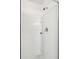 Close-up of a modern shower with white tile, a built-in shelf, and sleek fixtures at 2254 Show Basket Way, Mount Pleasant, SC 29466