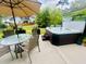 Backyard patio featuring a spa and outdoor dining under a large umbrella at 2324 Town Woods Rd, Charleston, SC 29414