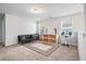 Bright bonus room featuring a comfortable futon couch and storage shelving at 2324 Town Woods Rd, Charleston, SC 29414