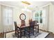 Bright dining room with dark wooden table, area rug, and windows providing natural light at 2324 Town Woods Rd, Charleston, SC 29414
