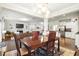 The dining room showcases hardwood floors, an elegant lighting fixture, and backyard views at 2324 Town Woods Rd, Charleston, SC 29414