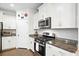 Well-lit kitchen with stainless steel appliances, granite countertops, and white cabinets at 2324 Town Woods Rd, Charleston, SC 29414