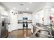 Modern kitchen with stainless steel appliances, granite countertops, white cabinets, and wood floors at 2324 Town Woods Rd, Charleston, SC 29414