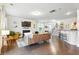 Open-concept living room with hardwood floors, a fireplace, and seamless flow to the kitchen and dining area at 2324 Town Woods Rd, Charleston, SC 29414