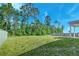 Expansive backyard with mature trees and a partial fence offers privacy and space for outdoor enjoyment at 239 Parkwood Vista Way, Summerville, SC 29486