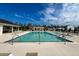 Modern community pool with poolside seating, palm trees, umbrellas, pergola, and grassy areas at 239 Parkwood Vista Way, Summerville, SC 29486