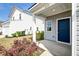 Charming front entry featuring a covered porch and a modern navy blue door at 239 Parkwood Vista Way, Summerville, SC 29486