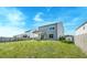 The backyard showcases the house's covered patio and expansive green space, bordered by trees and a fence at 239 Parkwood Vista Way, Summerville, SC 29486