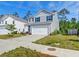 Two-story home features gray siding, a two-car garage, an unfinished yard, and a blue sky at 239 Parkwood Vista Way, Summerville, SC 29486