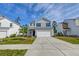 Two-story home with gray siding, blue shutters, a two-car garage, and an unfinished front yard at 239 Parkwood Vista Way, Summerville, SC 29486