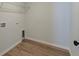 Convenient laundry room with wood-look vinyl flooring and utility connections at 239 Parkwood Vista Way, Summerville, SC 29486