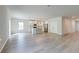 Spacious living room with light wood flooring and a view into the modern kitchen with an island at 239 Parkwood Vista Way, Summerville, SC 29486