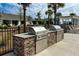 Outdoor kitchen area features brick accents, stainless grills, and a clean, modern design at 239 Parkwood Vista Way, Summerville, SC 29486