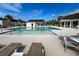 Community pool with lounge chairs, tables and shade in a neighborhood with lush landscaping and a blue sky at 239 Parkwood Vista Way, Summerville, SC 29486