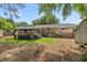 Backyard with well-maintained lawn, mature trees, and a gazebo with plenty of room for outdoor seating at 2404 Menola Ave, Charleston, SC 29414