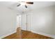 Bright bedroom featuring hardwood floors, ceiling fan, and closet for ample storage space at 2404 Menola Ave, Charleston, SC 29414