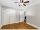 This spacious bedroom includes hardwood floors, a ceiling fan, and an adjacent bathroom at 2404 Menola Ave, Charleston, SC 29414