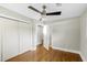 Cozy bedroom with hardwood floors, a ceiling fan, and closet space near the ensuite bathroom at 2404 Menola Ave, Charleston, SC 29414
