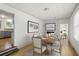 Dining room adjacent to kitchen features wood floors and wainscotting at 2404 Menola Ave, Charleston, SC 29414