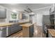 Kitchen features grey cabinets, stainless steel appliances, and wood countertop island at 2404 Menola Ave, Charleston, SC 29414