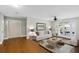 Bright living room features hardwood floors, ceiling fan and French doors to backyard at 2404 Menola Ave, Charleston, SC 29414