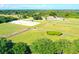 Expansive aerial view of the horse farm with lush green pastures, riding arena, and well-maintained stables at 2624 Jenkins Point Rd, Seabrook Island, SC 29455