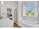 Bright bathroom featuring a soaking tub, a walk-in shower, and stylish fixtures at 2624 Jenkins Point Rd, Seabrook Island, SC 29455