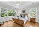 Bright bedroom with large windows, hardwood floors, and neutral tones at 2624 Jenkins Point Rd, Seabrook Island, SC 29455