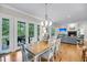 Open-concept dining area with wood floors, natural light, and seamless access to the living room at 2624 Jenkins Point Rd, Seabrook Island, SC 29455