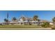 Exterior view of a multi-story home featuring multiple balconies, lush landscaping, and a manicured lawn at 2624 Jenkins Point Rd, Seabrook Island, SC 29455
