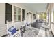 Inviting front porch with rocking chairs, porch swing, and stylish decor for relaxing outdoors at 2624 Jenkins Point Rd, Seabrook Island, SC 29455