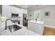 Bright kitchen featuring an island, stainless steel appliances, and white cabinets at 2624 Jenkins Point Rd, Seabrook Island, SC 29455