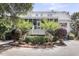 Landscaped rear of the property featuring a charming screened porch and upper level balcony at 2624 Jenkins Point Rd, Seabrook Island, SC 29455