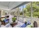 Inviting screened porch with a mix of seating options and scenic views of nature at 2624 Jenkins Point Rd, Seabrook Island, SC 29455