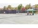 Outdoor tennis court with players, net, and green canopy at 2624 Jenkins Point Rd, Seabrook Island, SC 29455