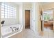 Large soaking tub in bathroom with window at 3101 S Shore Dr, Charleston, SC 29407