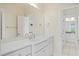 Elegant bathroom showcasing a large mirror and white vanity with access to other rooms at 3101 S Shore Dr, Charleston, SC 29407