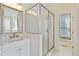 Bathroom featuring a glass shower, granite vanity, and an ornate mirror at 3101 S Shore Dr, Charleston, SC 29407