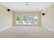Spacious bedroom featuring large windows, french doors, neutral carpet and ceiling fan at 3101 S Shore Dr, Charleston, SC 29407