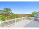 Large deck with white railings, offering scenic views of marshland and blue sky at 3101 S Shore Dr, Charleston, SC 29407