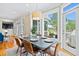 Dining area with seating for six flows from a living area offering access to a deck at 3101 S Shore Dr, Charleston, SC 29407