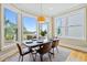 Sunlit dining area provides seating for six and expansive outdoor views through large windows at 3101 S Shore Dr, Charleston, SC 29407