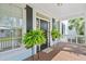 Charming front porch with potted ferns and a light-blue ceiling at 3101 S Shore Dr, Charleston, SC 29407