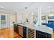 Kitchen island with granite countertops, a wine cooler, and seating faces living and dining areas at 3101 S Shore Dr, Charleston, SC 29407
