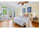 Bright main bedroom features wood floors, access to a deck, and a ceiling fan at 3101 S Shore Dr, Charleston, SC 29407