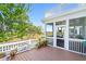 Well-maintained screened porch with plants and marsh views, perfect for relaxation at 3101 S Shore Dr, Charleston, SC 29407