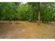 Backyard with a firepit, chicken coop and mature trees at 312 Piney Grove Rd, Cross, SC 29436